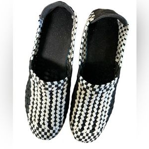 Woven black and white slip on shoe with a white wedge heel. Size is 40 = 8.5